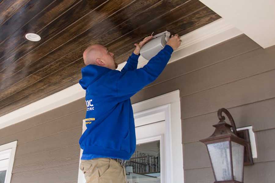 CMC Electric technician installing outdoor porch wiring in Clayton