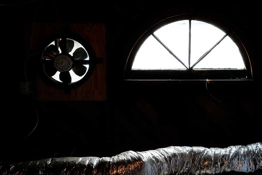 Attic ventilation fan operating inside a residential attic in Raleigh