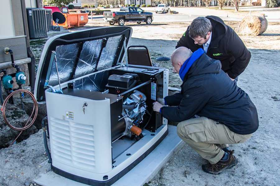 Electricians servicing a standby generator during installation in Clayton, NC
